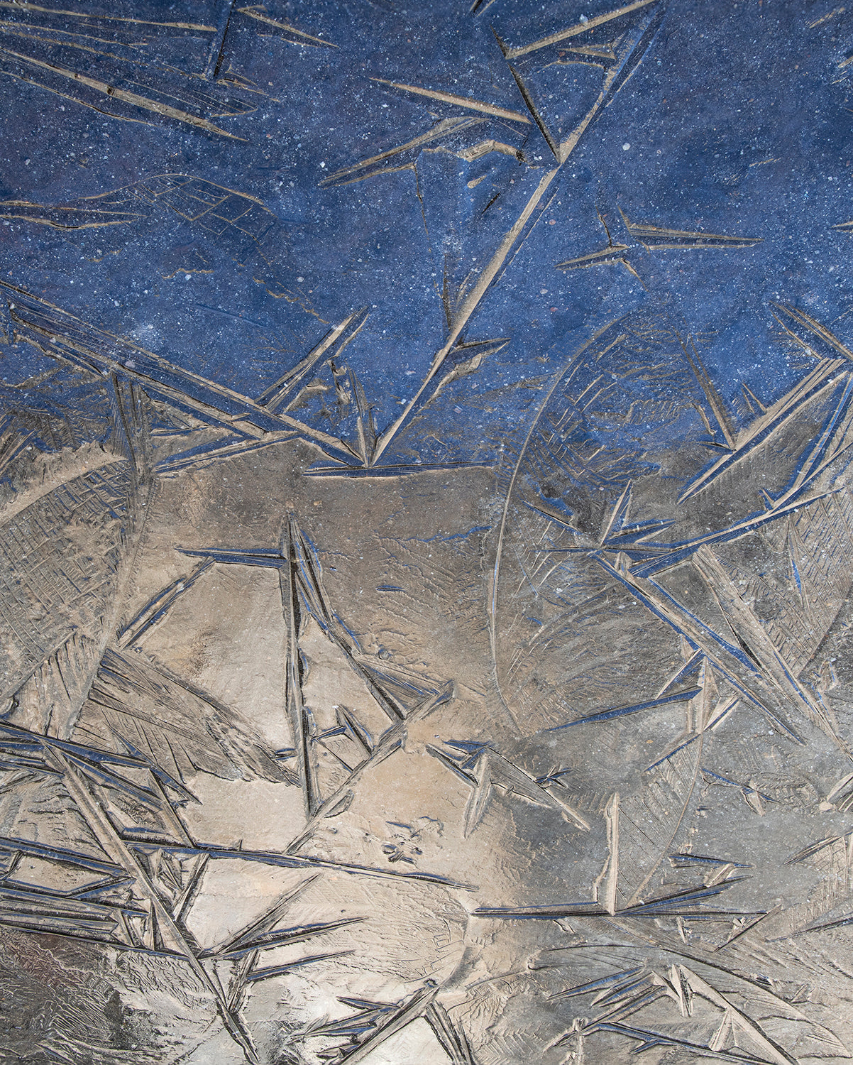 Close-up of ice crystals on a surface with a blue and gray color scheme by Franka Gabler